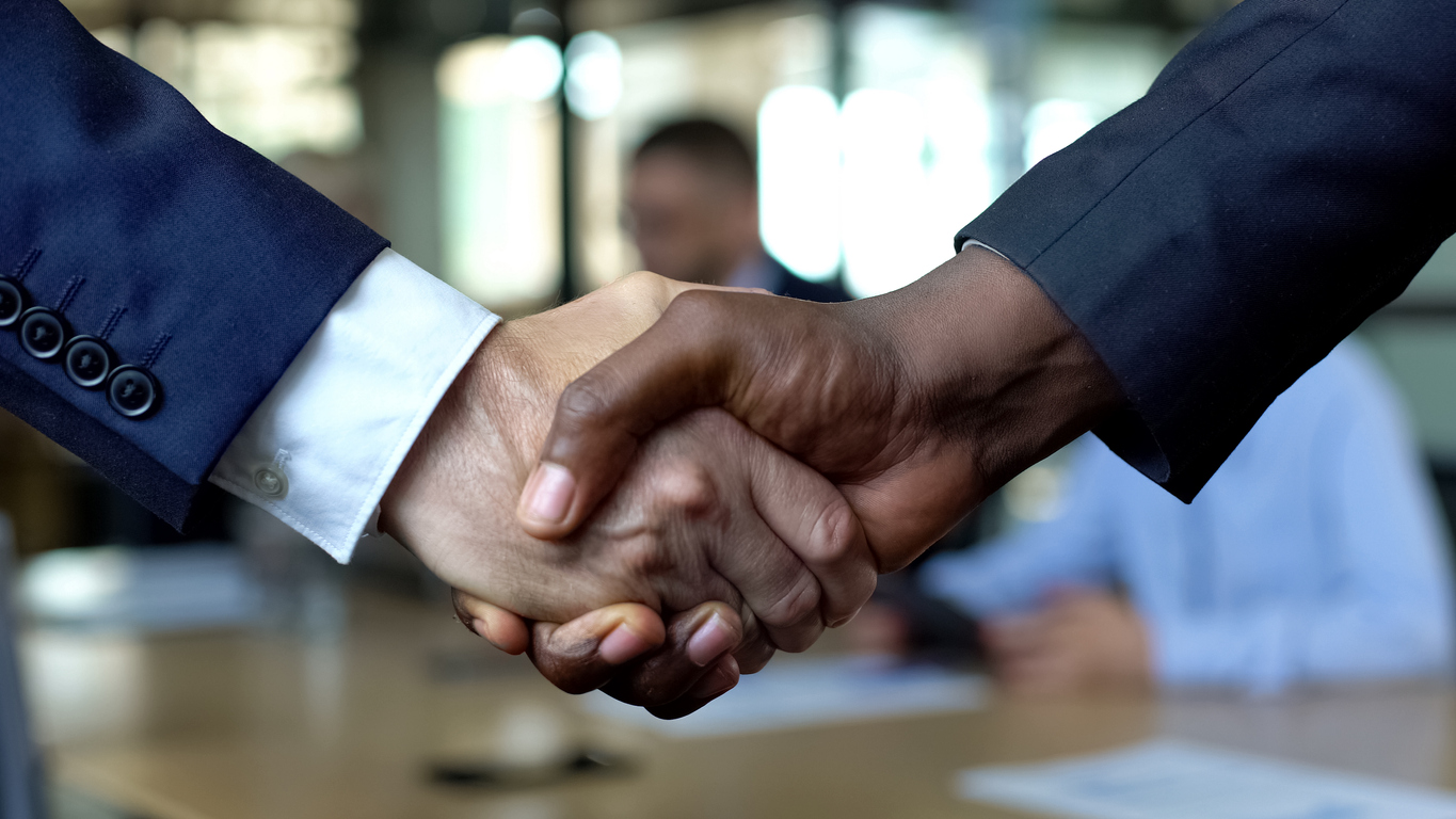 Business handshake close-up, partners shaking hands for agreement approval